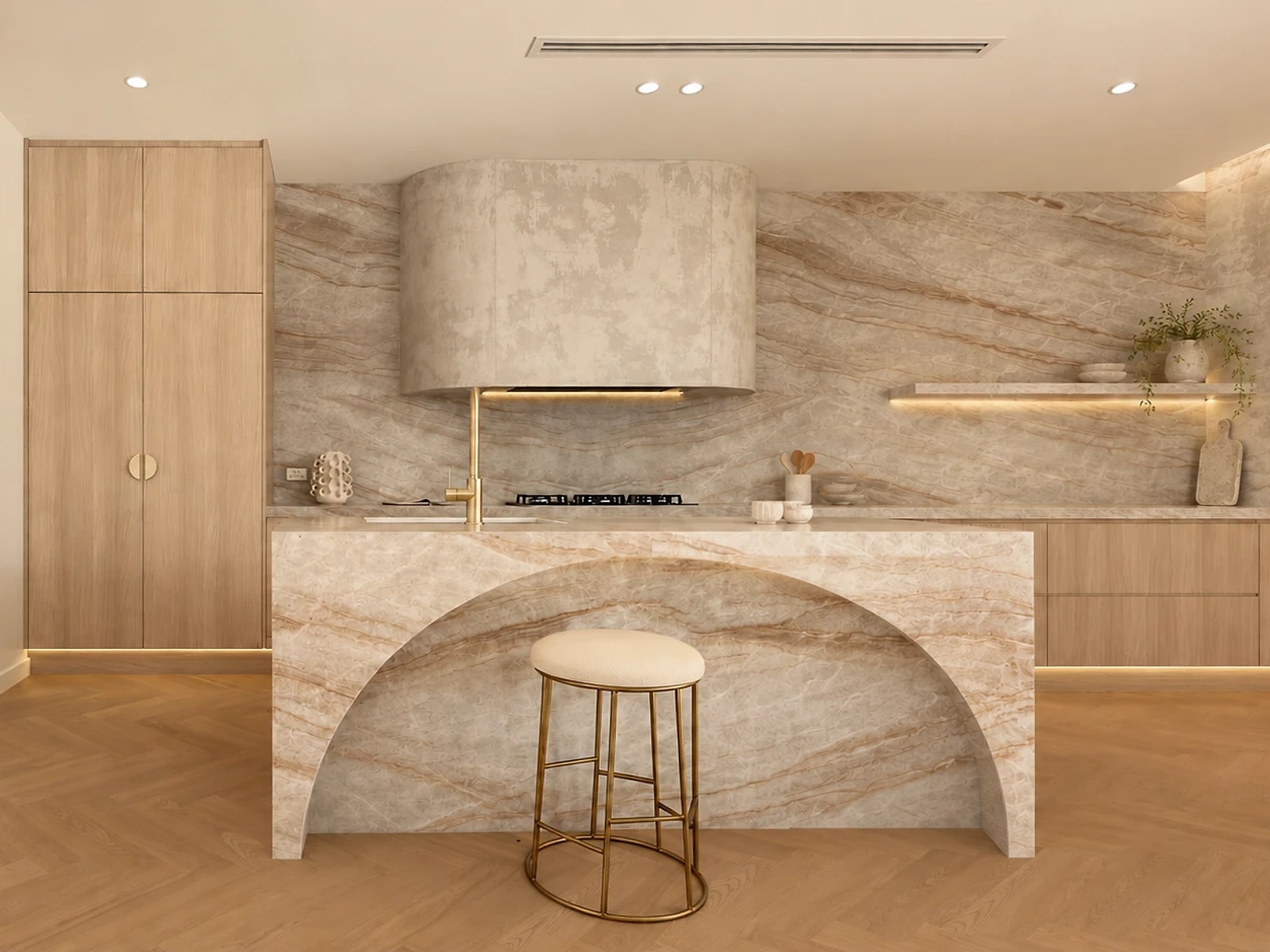 Kitchen island with a curved marble skirt, herringbone oak flooring